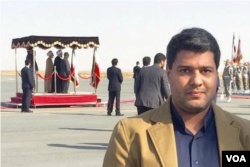 عکسی که رویترز از امیر مقدم در حاشیه یکی از سفرهای استانی روحانی در اراک منتشر کرده است.
