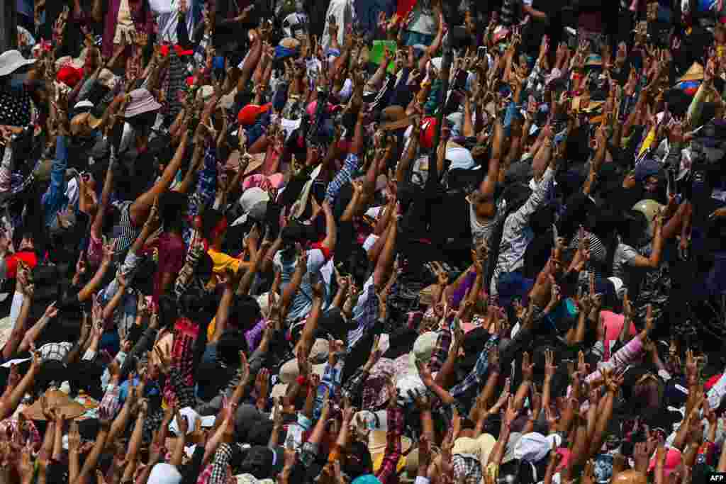 Mourners give the three-finger salute during the funeral service for Nyi Nyi Aung Htet Naing, who died from a gunshot wound while attending a demonstration against the military coup, in Yangon, Myanmar.