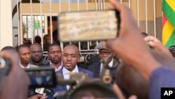 FILE - Zimbabwean main opposition leader Nelson Chamisa, center, talks to the press outside the nomination court in Harare, Zimbabwe, June 21, 2023.