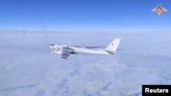 Russian Tu-95MS strategic bomber performs a flight over the neutral waters of the Bering Sea