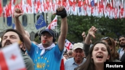 (FILE) Demonstrators hold a rally to protest against a bill on "foreign agents", after Georgia's parliament voted to override a presidential veto of the bill, in Tbilisi, Georgia, May 28, 2024.