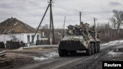 Ukrainian servicemen ride an Armored Personnel Carrier (APC), as Russia's attack on Ukraine continues, in the village of Torske, Donetsk region, Ukraine Dec. 30, 2022. 