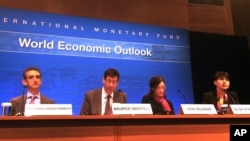 From left, Gian Maria Milesi-Ferretti, deputy director in the Research Department; Maurice Obstfeld, director of Research; Oya Celasun, deputy Division Chief in the Western Hemisphere Department; and spokeperson Olga Stankova hold a news conference at the International Monetary Fund in Washington, April 18, 2017. 