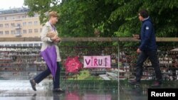 Pedestrians walk over a bridge after the Slovenian government called an official end to its coronavirus disease (COVID-19) epidemic, in Ljubljana, Slovenia, May 15, 2020. 