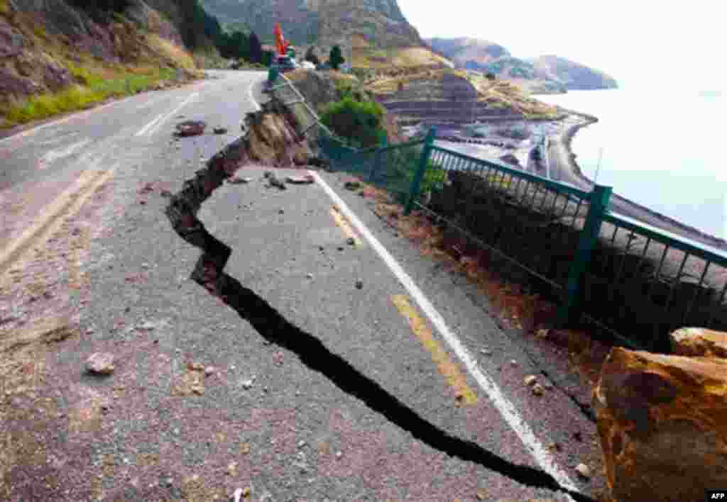 Part of a road between Lyttelton and Sumner is damaged by Tuesday's earthquake on the outskirts of Christchurch, New Zealand. (AP/Mark Baker)