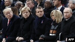 FILE - From left, President Donald Trump, German Chancellor Angela Merkel, French President Emmanuel Macron and his wife Brigitte Macron, and Russian President Vladimir Putin attend an Armistice Day ceremony in Paris, France, Nov. 11, 2018.