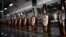 FILE - Bottles of Santa Teresa "Gran Reserva" rum move along the assembly line at the factory in La Victoria, Aragua State, Venezuela, March 26, 2015.