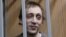 Dancer Pavel Dmitrichenko looks out from the defendant's holding cell during a hearing in Moscow on October 22, 2013. 