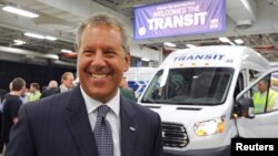 FILE - Joe Hinrichs, Ford president of The Americas, celebrates after driving the first Ford Transit Van from the assembly line at a Ford plant in Claycomo, Missouri, on Apr. 30, 2014. 