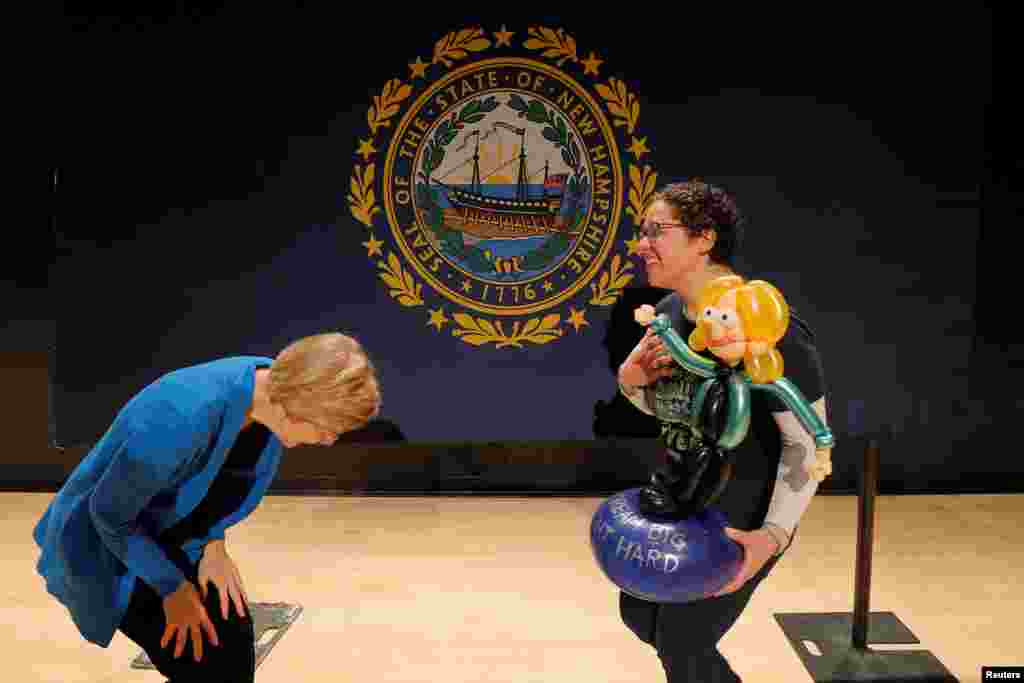 Democratic 2020 presidential candidate and Senator Elizabeth Warren (D-MA) reacts as Naomi Greenfield carries a balloon figure of Warren at a GOTV campaign event in Nashua, New Hampshire, Feb. 5, 2020.