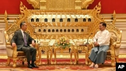 This photo provided by Myanmar Military Information Team, Myanmar's military leader Senior Gen. Min Aung Hlaing, right, chairman of State Administration Council, talks with Chinese Foreign Minister Wang Yi, Aug. 14, 2024, in Naypyitaw, Myanmar. 