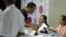 A voter registers to cast his ballot at a polling station in Yangon, Myanmar, Nov. 3, 2018.