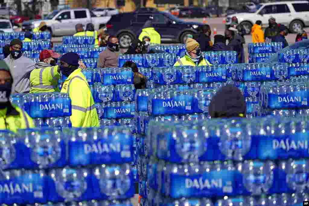 Water to be loaded into vehicles is stacked at a City of Houston water distribution site. The location was set up to provide bottled water to individuals while the city remains on a boil water notice or because of frozen pipes at home.