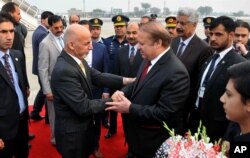 Pakistani Prime Minister Nawaz Sharif, center right, greets Afghan President Ashraf Ghani, center left, upon his arrival at Nur Khan airbase in Rawalpindi, Pakistan, Dec. 9, 2015.