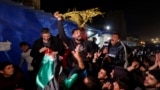 Palestinians react to news on a ceasefire deal with Israel, in Khan Younis in the southern Gaza Strip, Jan. 15, 2025. 