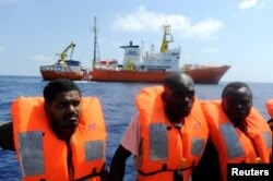 Migrants are rescued by SOS Mediterranee organization and Doctors Without Borders during a search and rescue operation with the MV Aquarius rescue ship, off the Libyan Coast, Aug. 10, 2018.