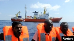 Migrants are rescued by SOS Mediterranee organization and Doctors Without Borders during a search and rescue operation with the MV Aquarius rescue ship, off the Libyan Coast, Aug. 10, 2018. 