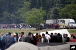 Migrants and refugees line up for food distribution at the northern Greek border point of Idomeni, Greece, May 2, 2016.