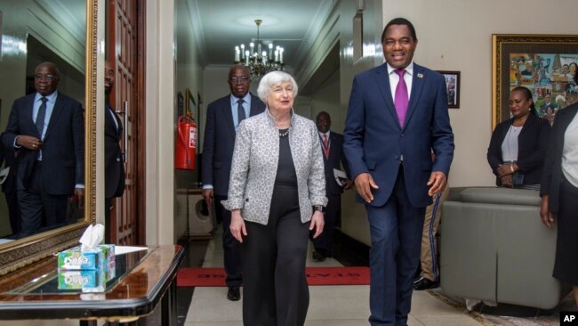 U.S. Treasury Secretary Janet Yellen walks with Zambia's President Hakainde Hichilema during their meeting at the State House in Lusaka, Zambia, Jan. 23, 2023.
