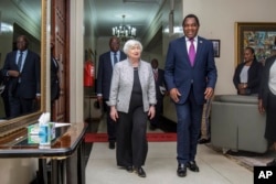 FILE — U.S. Treasury Secretary Janet Yellen walks with Zambia’s President Hakainde Hichilema during their meeting at the State House in Lusaka, Zambia, Jan. 23, 2023.