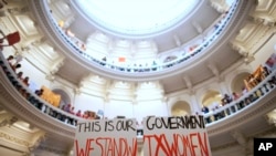 FILE - Abortion rights supporters rally on the floor of the State Capitol rotunda in Austin, Texas on July 12, 2013.