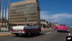 Tourists ride classic convertible cars on the Malecon in Havana, Cuba, Oct. 3, 2017. 