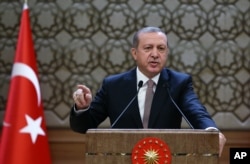 Turkish President Recep Tayyip Erdogan addresses local administrators at his palace in Ankara, Turkey, Nov. 26, 2015.