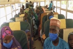 Homeward bound Nigerians are seen on a chartered schoolbus in Maroua, northern Cameroon, March 8, 2021. (Moki Edwin Kindzeka/VOA)