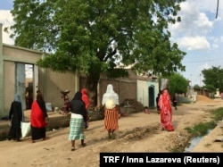 Women walking on a road in downtown N'Djamena, Chad, a country embroiled in a deep economic, security and humanitarian crisis, where state funding is scarce and not a single law assures any rights for disabled people, Sept. 23, 2017.
