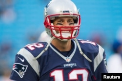 FILE - New England Patriots quarterback Tom Brady (12) stands on the field during warm ups prior to the game against the Carolina Panthers at Bank of America Stadium, Charlotte, North Croloina, Aug 26, 2016.