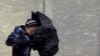 A pedestrian walks into wind-driven snow in Boston, Massachusetts, Feb. 8, 2013.