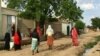 FILE - Women walking on a road in downtown N'Djamena, Chad, Sept. 23, 2017. 