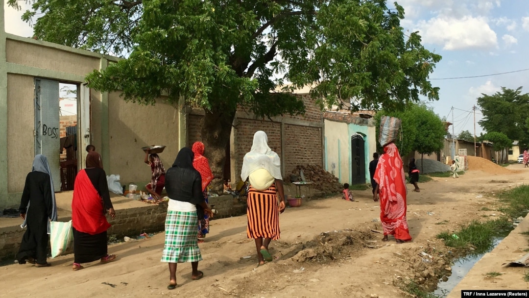 FILE - Women walking on a road in downtown N'Djamena, Chad, Sept. 23, 2017. 