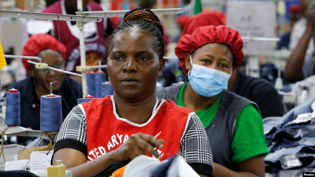 FILE - Norah Nasimiyu works on denim trousers for export at the United Aryan Export Processing Zone (EPZ) factory, operating under The U.S. African Growth and Opportunity Act (AGOA), in Ruaraka district of Nairobi, Kenya October 26, 2023.