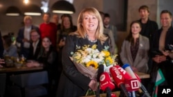 Leader of the Social Democrats, Vilija Blinkeviciute, speaks to the media while awaiting the results of the first round of Lithuania's parliamentary election, in Vilnius, Lithuania, Oct. 13, 2024.