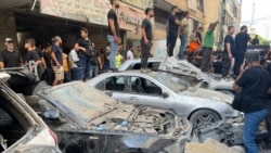 People gather at the scene of an Israeli missile strike in the southern suburbs of Beirut on Sept. 20, 2024. 