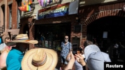 People gather outside The Stonewall Inn, on the 50th anniversary of the Stonewall Riot, in the Greenwich village area of New York, U.S., June 28, 2019. 