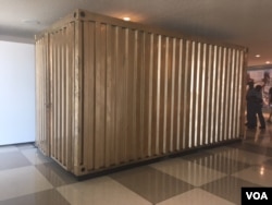 The refurbished shipping container/portal will remain at the U.N. public lobby in New York for 3 months, allowing visitors to connect with Syrian refugees. (M. Besheer/VOA)