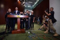 Pro-democracy lawmakers, including Democratic Party politician Lam Cheuk-ting, second left, hold a press conference outside the Legislative Council chamber in Hong Kong, Oct. 17, 2019.