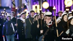 The Students' Independence Day Parade passes the Presidential Palace in Helsinki, Finland, Dec. 6, 2017, as Finland celebrates the centenary of independence.