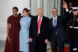 President Barack Obama and first lady Michelle Obama greets President-elect Donald Trump and his wife Melania Trump at the White House in Washington, Jan. 20, 2017.