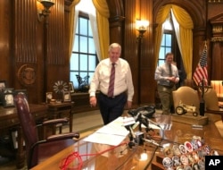 FILE - Missouri Gov. Mike Parson arrives for a news conference in his Capitol office in Jefferson City, May 14, 2019.