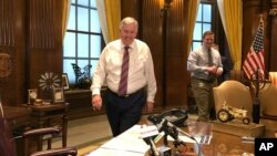 Missouri Gov. Mike Parson arrives for a news conference in his Capitol office in Jefferson City, Mo., May 14, 2019. Parson voiced support for an abortion ban bill on Wednesday.