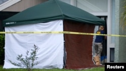 FBI agency enters the apartment of Ibragim Todashev, 27, in Orlando, Florida, May 22, 2013.