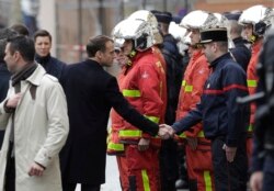 2018年12月2日黄色背心抗议油价上涨和生活成本上后, 法国总统马克龙在巴黎街头与消防员握手