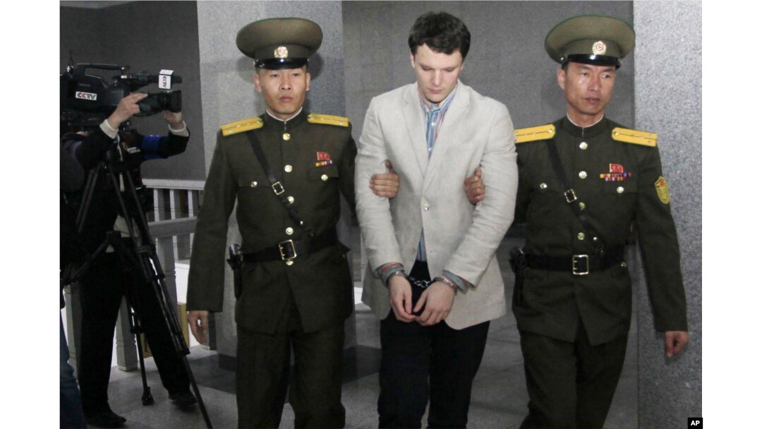 American student Otto Warmbier, center, is escorted at the Supreme Court in Pyongyang, North Korea, March 16, 2016. North Korea's highest court sentenced Warmbier to 15 years in prison after he allegedly attempted to steal a propaganda banner.