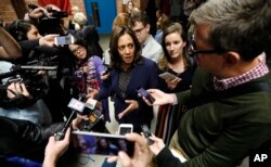 U.S. Sen. Kamala Harris, D-Calif., center, speaks to reporters following a get out the vote rally, Oct. 22, 2018, at Des Moines Area Community College in Ankeny, Iowa.
