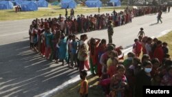 Women line up for food supplies at a camp for displaced earthquake victims in Kathmandu, Nepal, May 5, 2015.