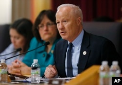 U.S. Rep. Mike Coffman, R-Colo. (front), makes a point while Rep. Ann Kuster, D-N.H., looks on during a House Veterans Affairs subcommittee field hearing, May 20, 2016, in the State Capitol in Denver.