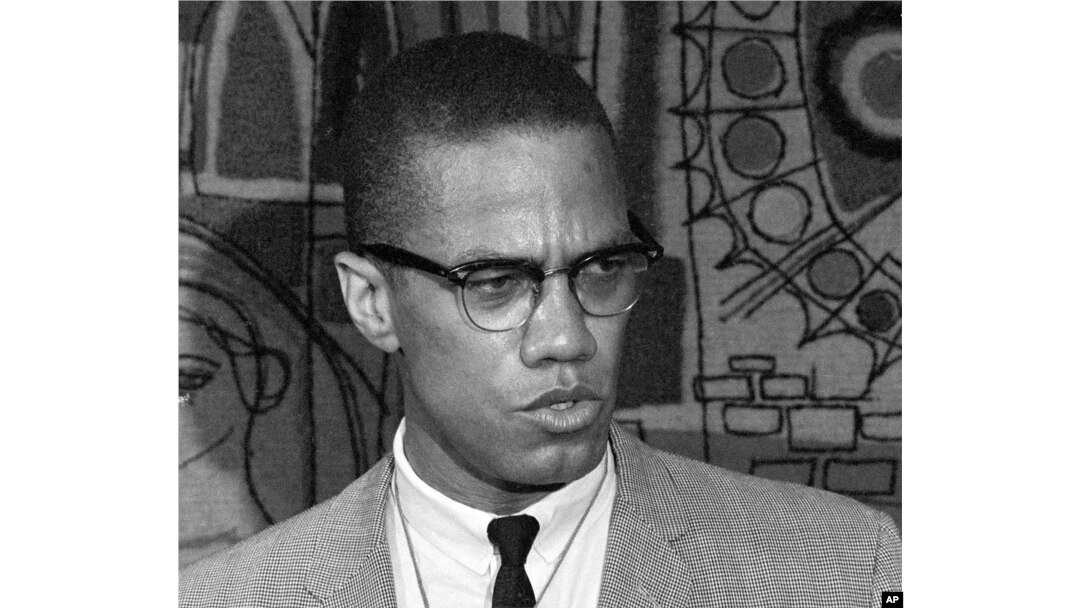 FILE - Malcolm X addresses reporters at what was then known as the Park Sheraton Hotel in New York, March 12, 1964.